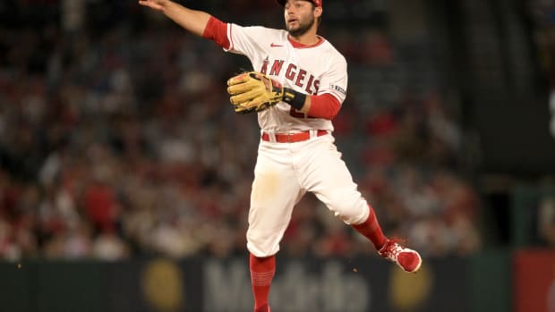 Jun 26, 2023; Anaheim, California, USA; Los Angeles Angels shortstop David Fletcher (22) throws Chicago White Sox center fielder Luis Robert Jr. (88) out at first in the eighth inning at Angel Stadium.